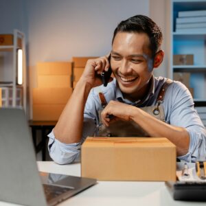 A business owner sells products on websites and online platforms. He is on the phone with a customer