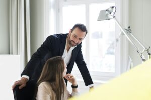 Businessman and employee talking at desk in office