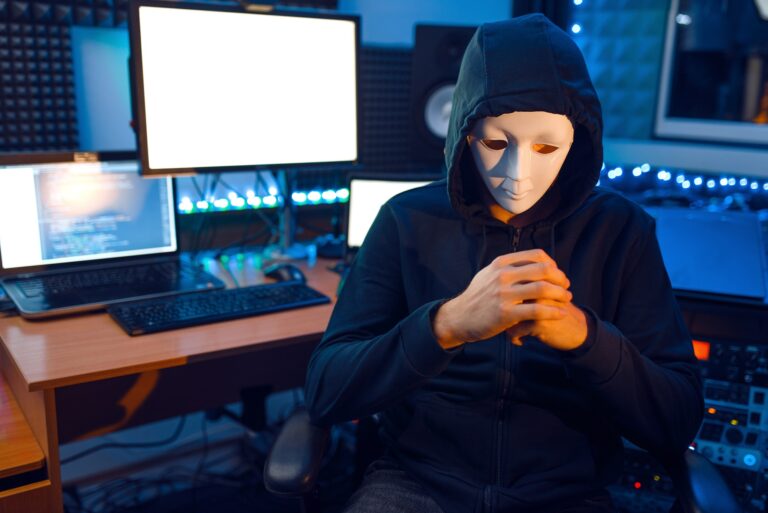 Hacker in mask and hood, illegal risk job